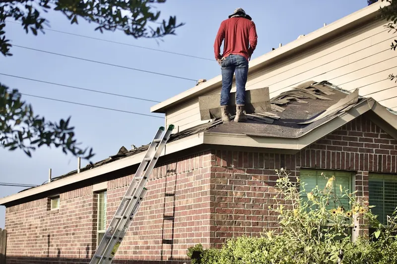 Professional roofer working on a residential roof in Sycamore West
